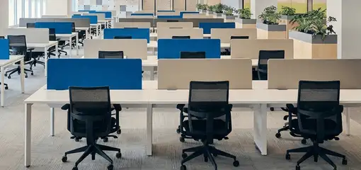 Modern open-plan office space featuring clean workstations, ergonomic chairs, and sanitized carpets provided by professional office cleaning services in Peoria, IL.