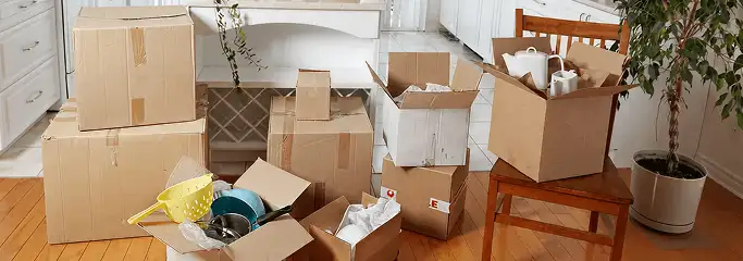 Packed moving boxes and household items in a kitchen before move-out or move-in cleaning, Peoria, IL.